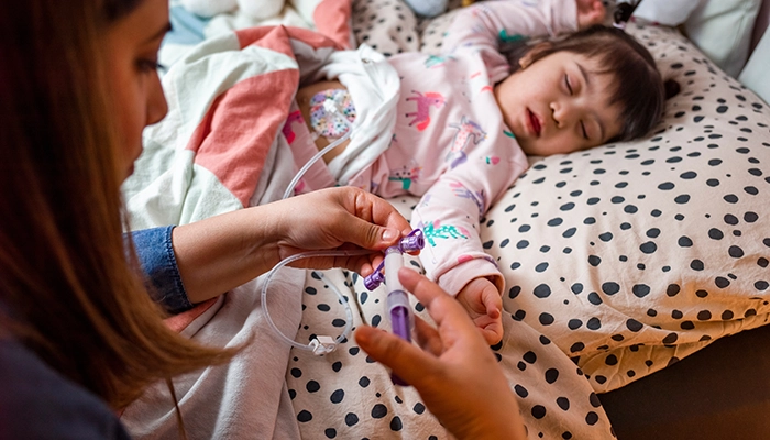 mom feeding daughter through a tube
